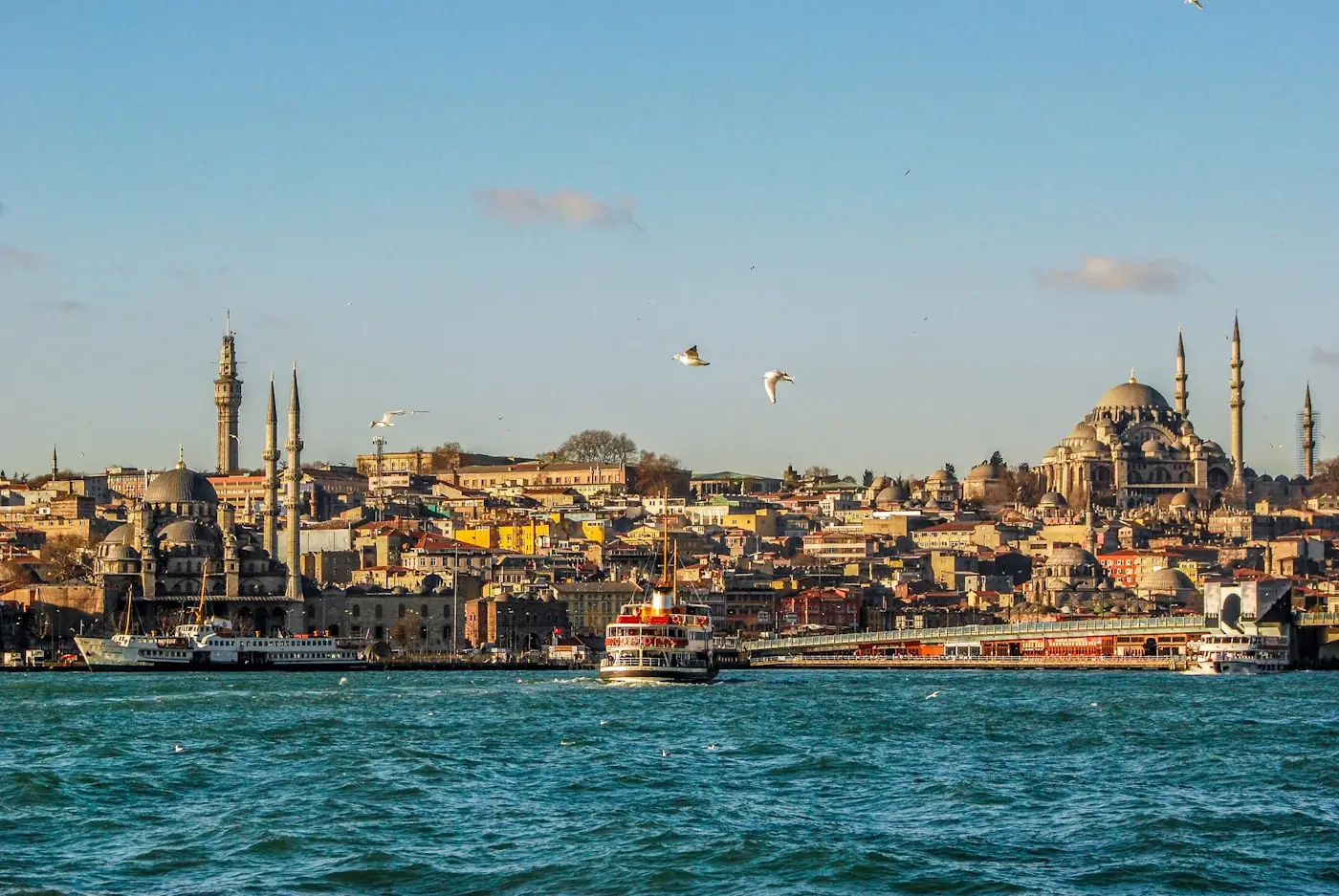 Istanbul seen from the water: the Golden Horn with the Galata Bridge, a passenger ferry and the Süleymaniye Mosque on the skyline